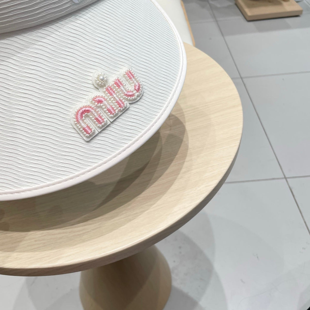 MIU MIU MM FASHION VISOR CAP IN BLACK AND WHITE WITH LOGO TEXT EMBROIDERY